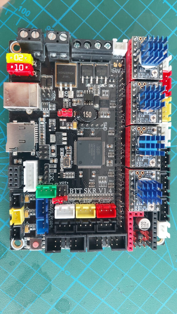 BTT SKR V1.4 control board with four plug-in stepper driver modules under blue heatsinks