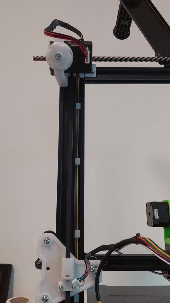 Z belt system on a printer upright: the Z motor at the top and a toothed belt running down to a printed gantry bracket
