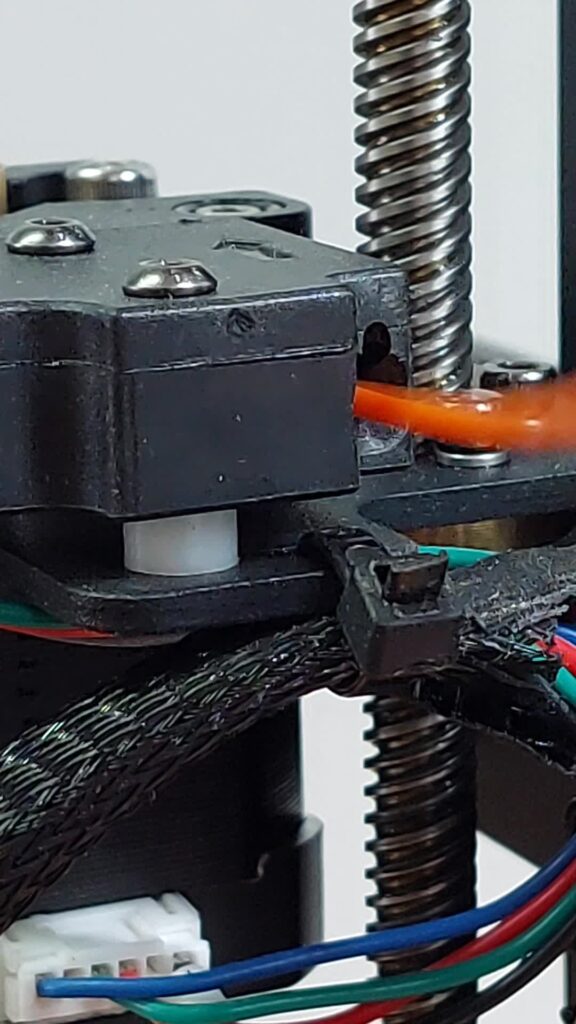 Z-axis stepper motor with its coupler and lead screw on a 3D printer frame