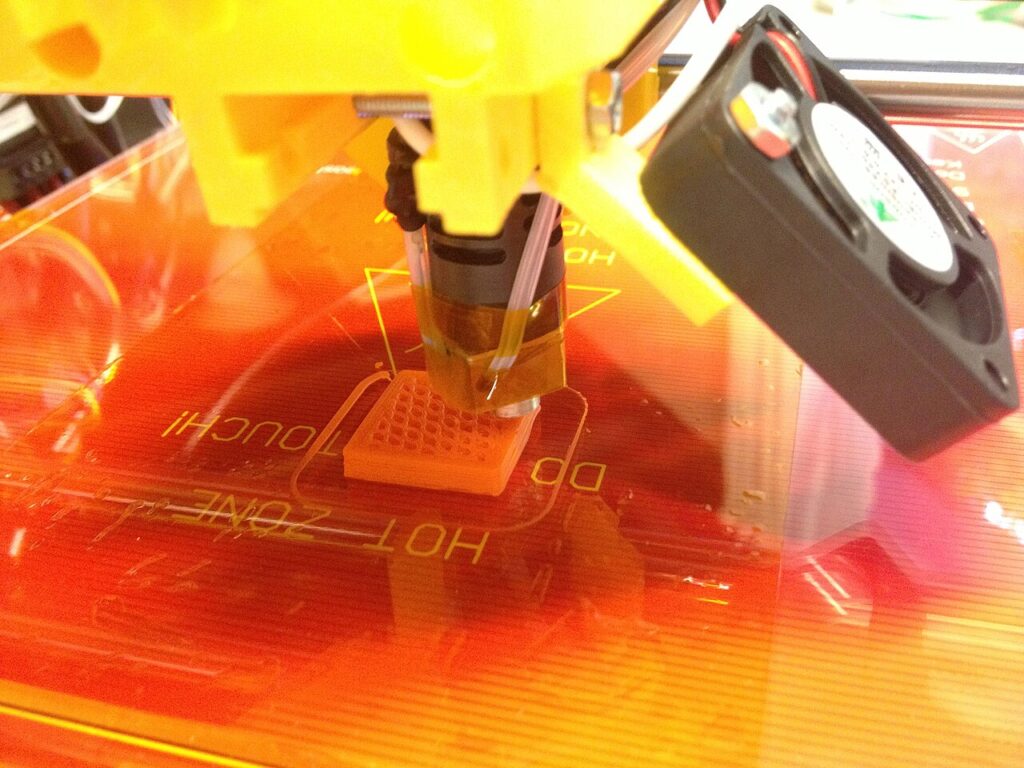 Open-frame Prusa i3 bed-slinger, the kind of setup used for printing ABS without an enclosure, with a part on its heated bed